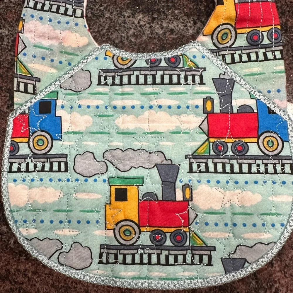 Handmade reversible quilted baby bib with train design